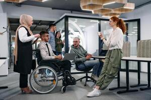 Young group of business people brainstorming together in a startup space, discussing business projects, investments, and solving challenges photo