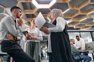 Young group of business people brainstorming together in a startup space, discussing business projects, investments, and solving challenges. photo