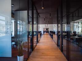 In a setting of modern, glass-walled business startup offices, the open, airy workspace reflects a contemporary and innovative ambiance, promising a dynamic environment for entrepreneurial growth photo