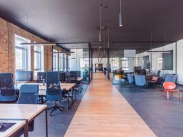 In a setting of modern, glass-walled business startup offices, the open, airy workspace reflects a contemporary and innovative ambiance, promising a dynamic environment for entrepreneurial growth photo
