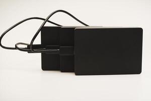 Modern data storage devices with USB wires.Hard drives. photo