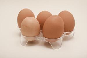 Chicken eggs . A brown egg on a white background. photo