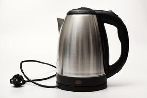 Electric kettle a white background. A metal teapot with a black handle. photo