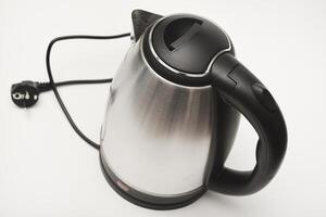 Electric kettle . A metal teapot with a black handle. photo