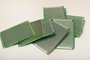 A green breadboard for electronics. The printed circuit board. photo