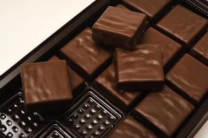 boxes of chocolate bars are shown on a white surface photo