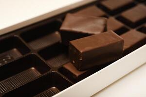 two boxes of chocolate bars shown on a white surface photo