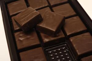chocolate bars are shown on a white surface photo