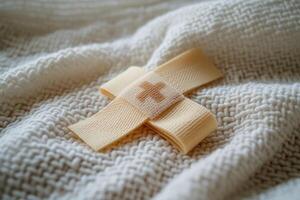 A small yellow cross on a white blanket photo