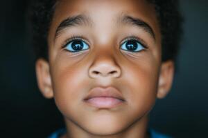 Young child with expressive eyes gazes intently photo