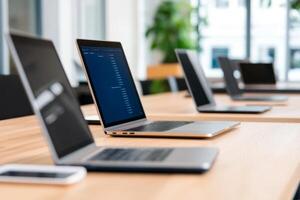 Workstations with laptops prepared for collaborative sessions in a modern office environment photo