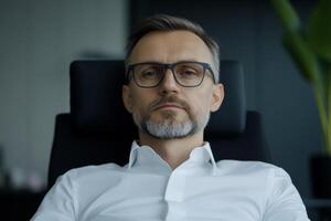 Confident businessman in modern office setting contemplating future strategies during work hours photo
