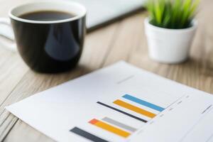 Coffee cup and business report on a wooden table highlight productivity and analysis in a modern workspace photo