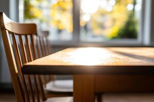 Warm sunlight illuminates a wooden table and chair in a cozy interior setting photo