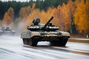 Military tanks maneuvering on a wet road surrounded by autumn trees in a training exercise photo