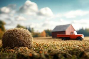 Farm landscape in autumn with hay bale and red barn under a cloudy sky photo