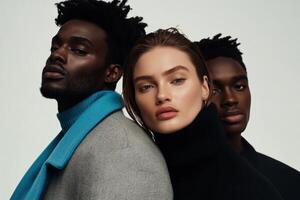 Three models pose together, showcasing contemporary fashion in a minimalistic studio setting photo