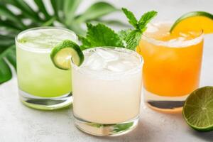 Colorful cocktails served with fresh garnishes on a marble countertop in a vibrant setting photo