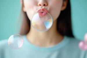 Girl blowing soap bubbles in a colorful and playful setting with a light blue background photo