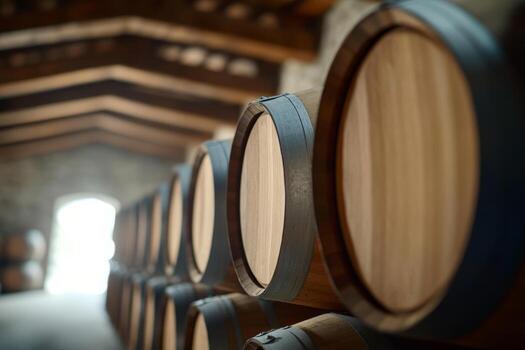 Wine barrels lined up in a rustic cellar with soft lighting and wooden architecture in the background photo