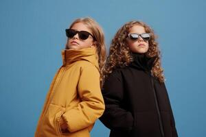 Kids showcase modern winter fashion with vibrant jackets against a blue background photo
