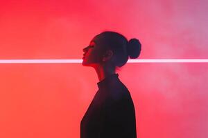 Woman silhouetted against vibrant red background with glowing line in urban setting photo