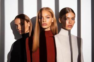 Three models posing under dramatic shadows in a minimalist studio setting photo