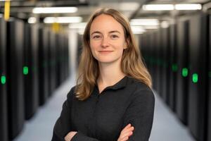 Confident woman standing in data center surrounded by computer servers and technology photo