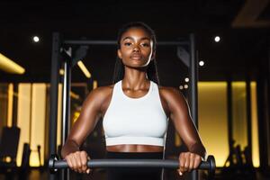 Strong woman exercising in a modern gym while focusing on her workout routine during the evening photo