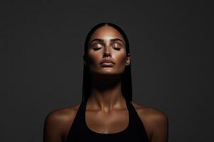 Powerful portrait of a woman with closed eyes in dramatic lighting showcasing tranquility and confidence photo