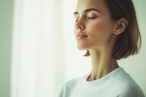 Peaceful woman practicing mindfulness in a bright, serene room during the day photo