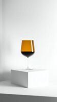 Elegant stacked glass with a gradient of dark and amber liquid against a minimalist backdrop photo