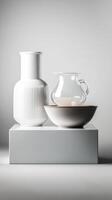Collection of minimalist white ceramics arranged on a pedestal showcasing their elegant design and textures in natural light photo