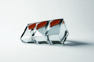 Glass sculpture reflecting vibrant colors and geometric shapes on a light backdrop in a studio setting photo