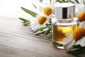 Delicate glass bottle of perfume resting on wooden surface surrounded by fresh chamomile flowers photo