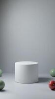 White cylindrical display surrounded by colorful spheres in a minimalist studio setting photo