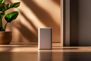 Modern white device placed on wooden floor near potted plant, basking in warm light during late afternoon photo