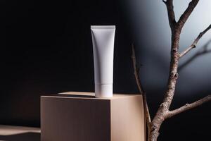 Product display of a white tube placed on a wooden pedestal with natural elements in a minimalist setting during soft lighting photo