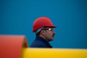 Worker in safety gear monitors operations at a construction site, showcasing safety measures and focus on responsibility photo