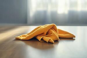 Cloth resting on a wooden table in a sunlit room during the morning hours photo
