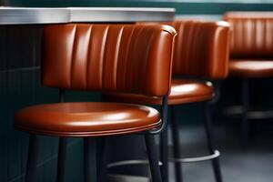 Stylish brown leather bar stools in a modern cafe setting during the day photo
