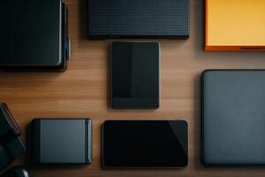 Modern workspace featuring various electronic devices and accessories on a wooden desk photo