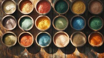 A variety of colored powders in wooden bowls photo