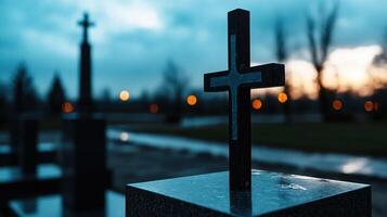 A black cross is on a stone pillar in a cemetery photo