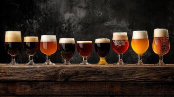 A row of beer glasses lined up on a wooden table photo