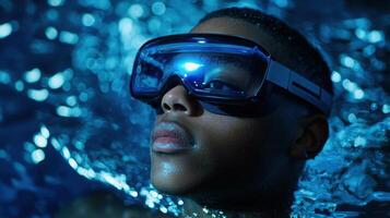 A young man wearing goggles in the water photo