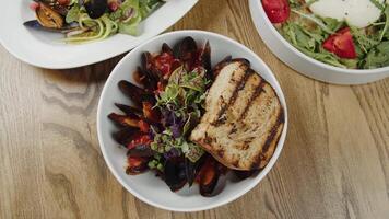 Bowl of Mussels in Tomato Sauce with Grilled Bread video