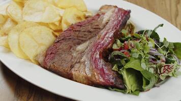 Grilled beef with potato chips and salad video