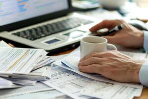 Professional Accountant Analyzing Financial Data with Desktop Software and Organized Documents photo