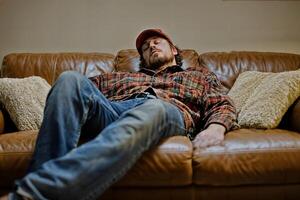 Exhausted Worker Relaxing on Couch After a Long Day at Work photo